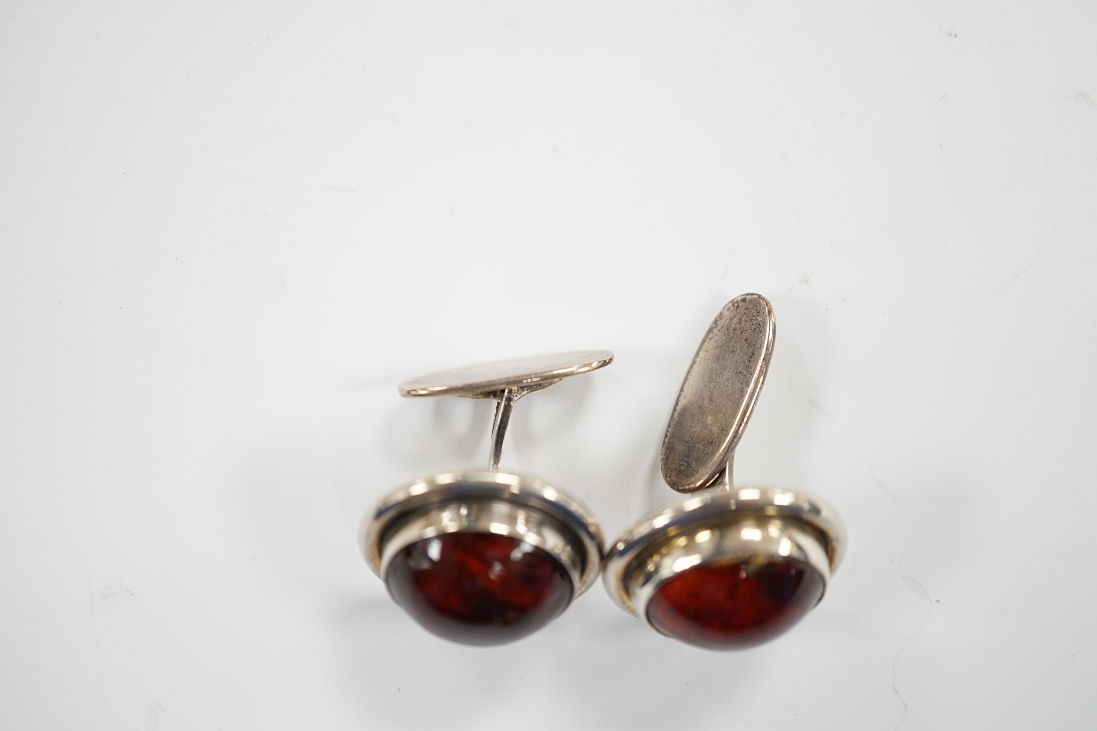 A pair of mid 20th century Danish sterling and cabochon amber set cufflinks, by Carl Ove Frydensberg, diameter 20mm.